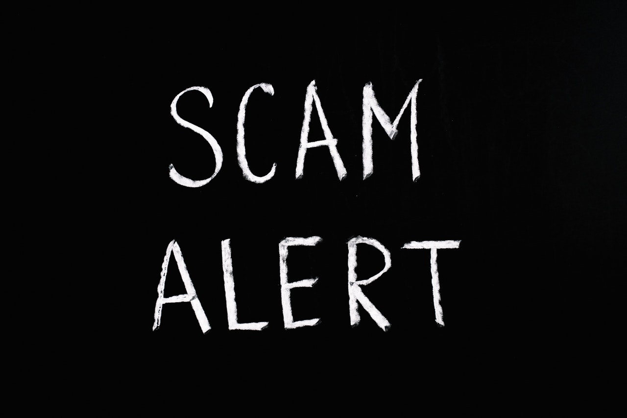 scam-alert-white-letters-black-background