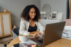 woman-in-white-blazer-using-laptop-computer